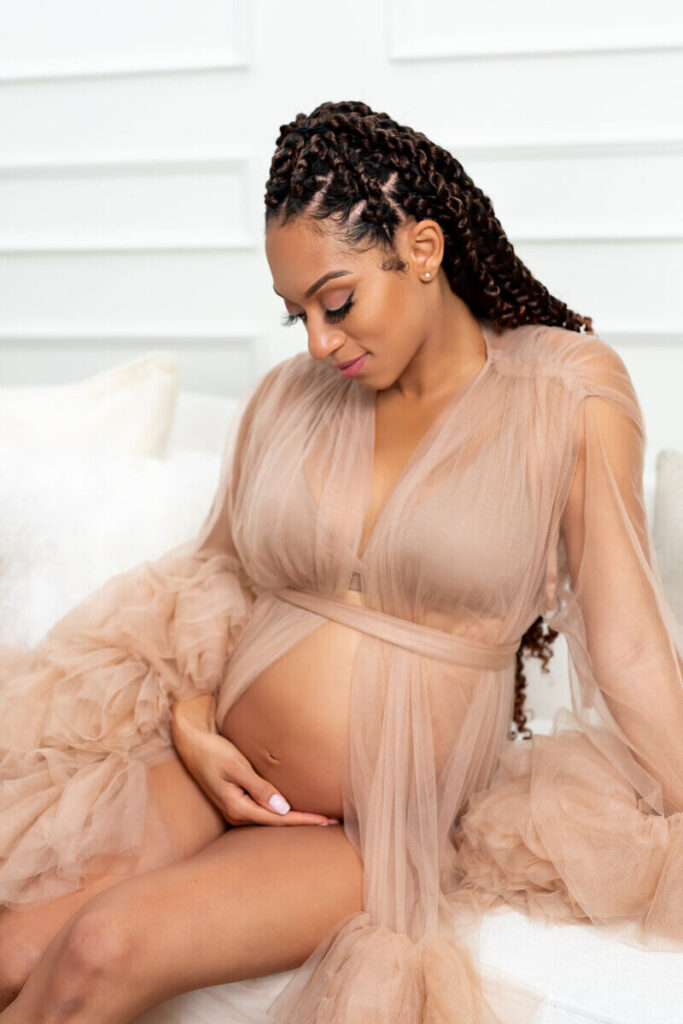 Woman looking at belly for maternity photoshoot